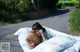 A little girl laying on a bed with a teddy bear.