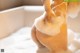 A close up of a person taking a bath in a bathtub.